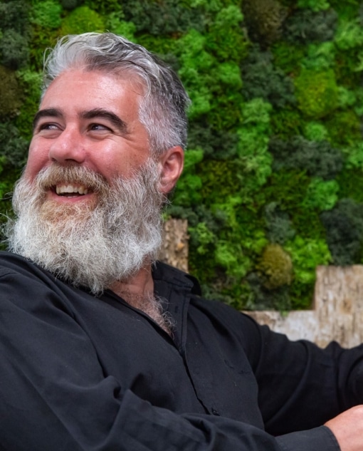 Creed Comms employee looking over shoulder smiling