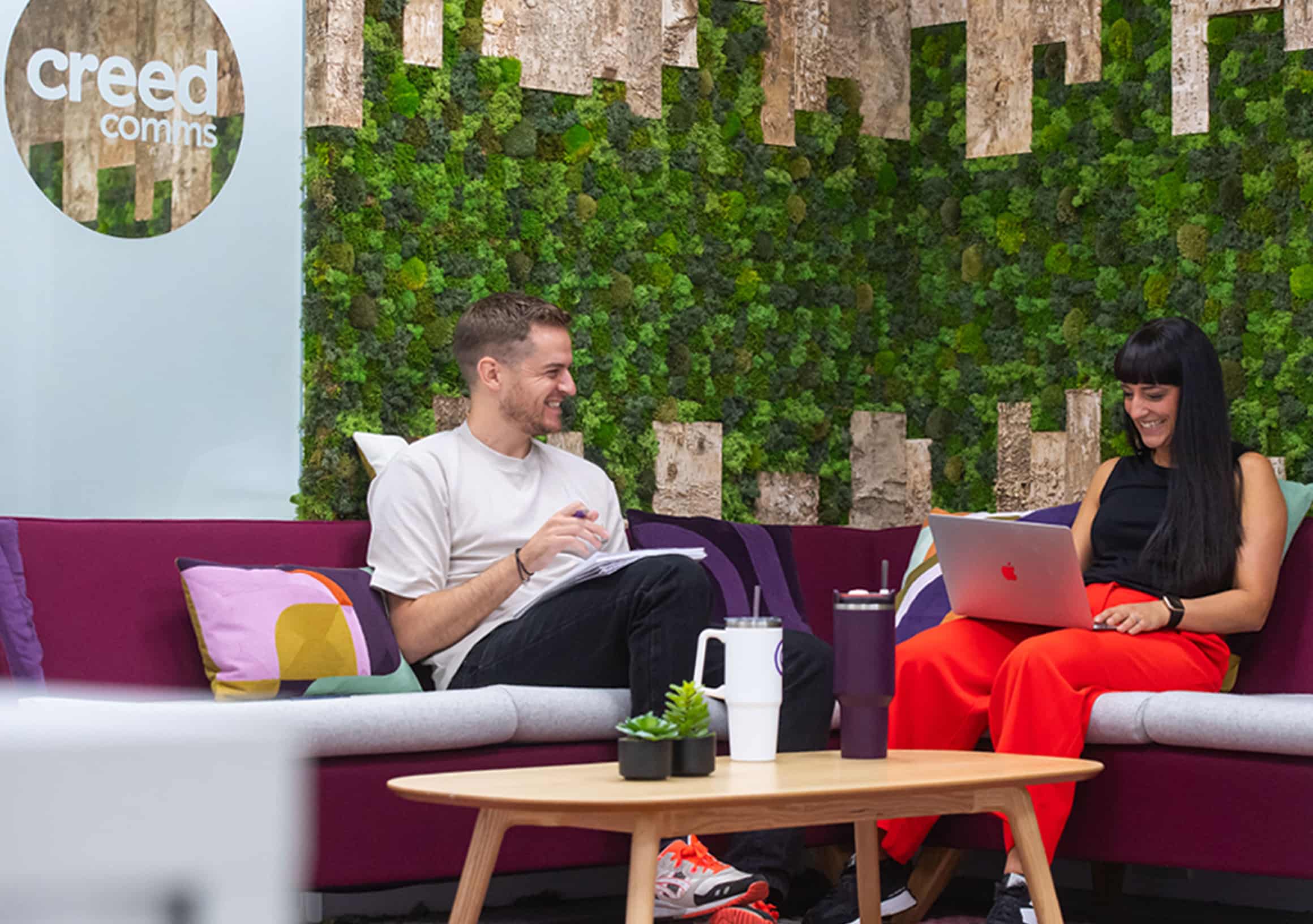 Two people sat on a sofa